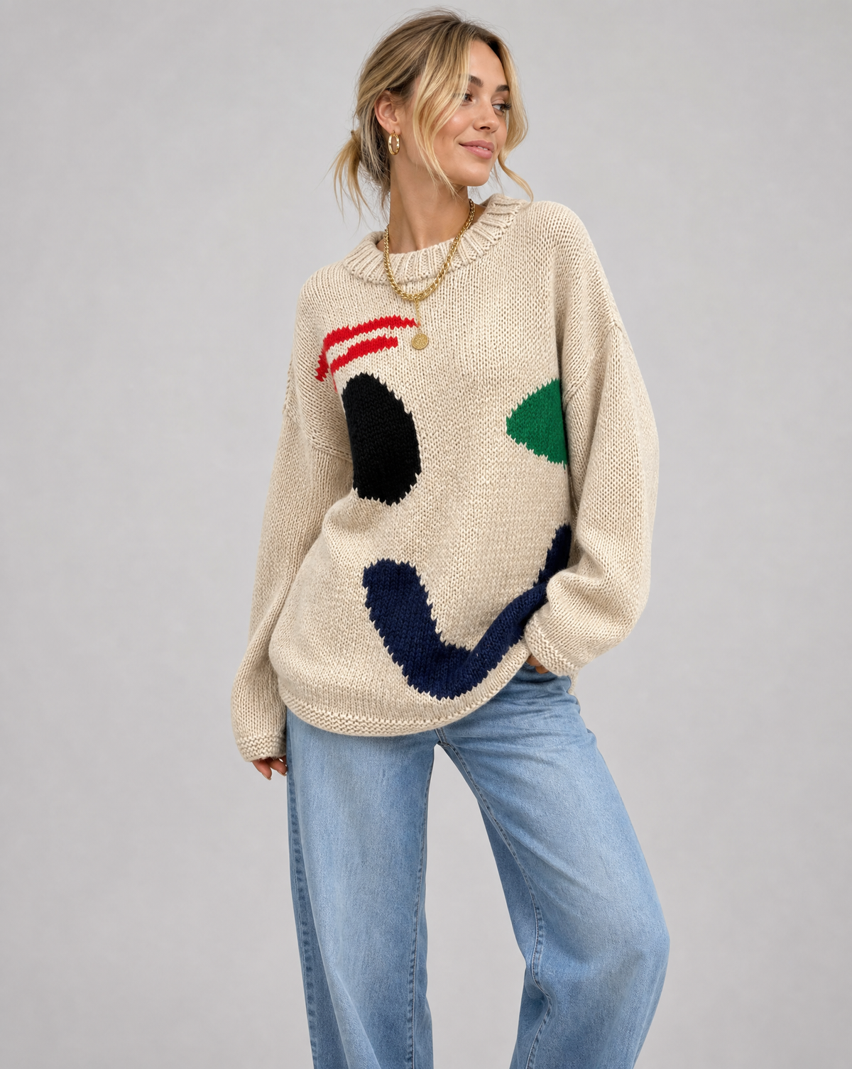 Damski sweter oversize z dzianinowym motywem uśmiechu