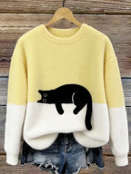 Damski sweter oversize z kontrastowym wzorem i czarnym motywem kota