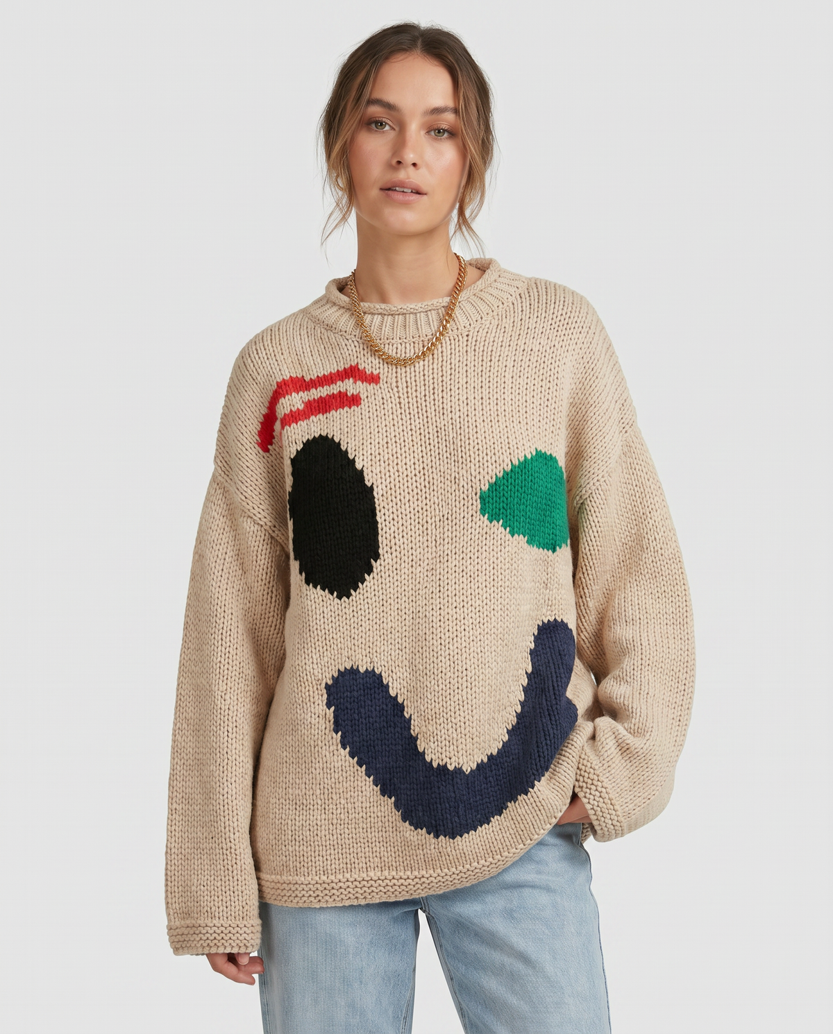 Damski sweter oversize z dzianinowym motywem uśmiechu