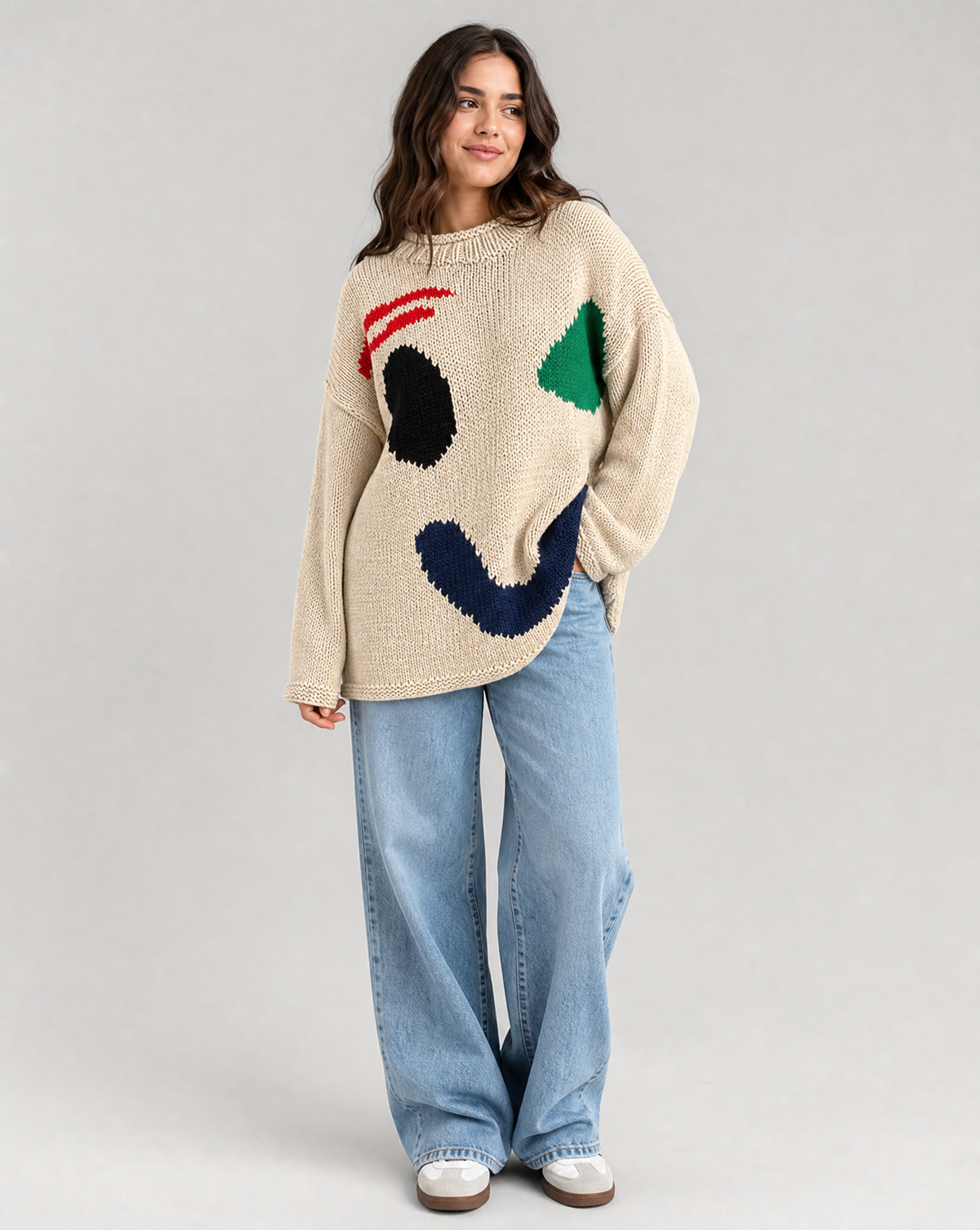 Damski sweter oversize z dzianinowym motywem uśmiechu