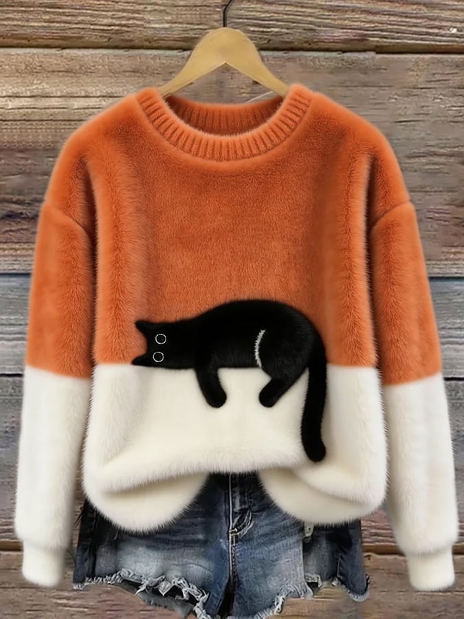 Damski sweter oversize z czarnym motywem kota i kontrastowymi panelami
